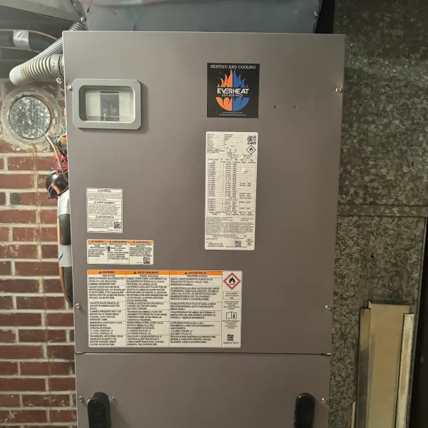 Air handler installed outside against a brick wall