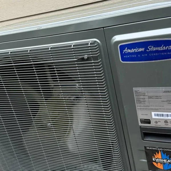 American Standard condenser installed on a concrete pad