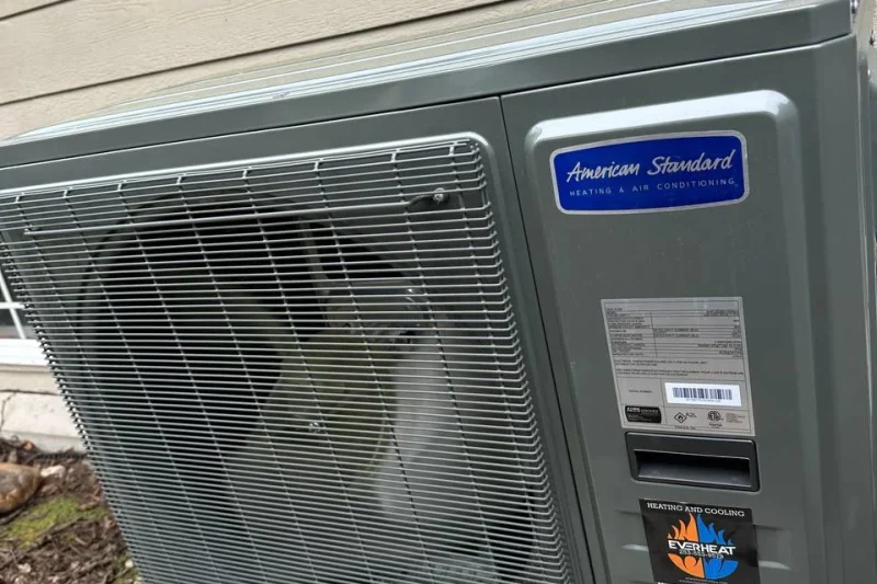 American Standard condenser installed on a concrete pad
