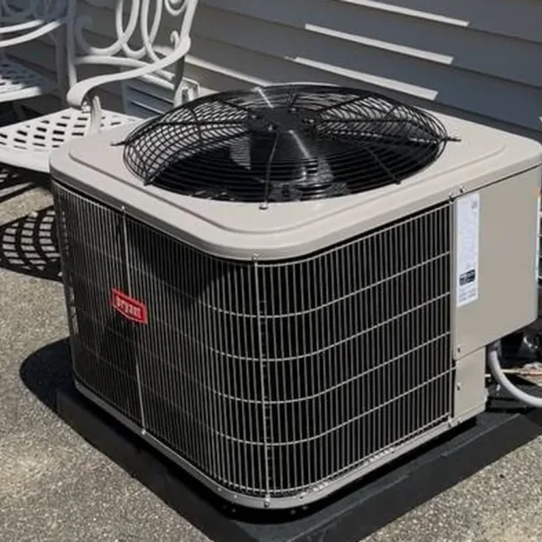 American Standard condenser installed beside a patio