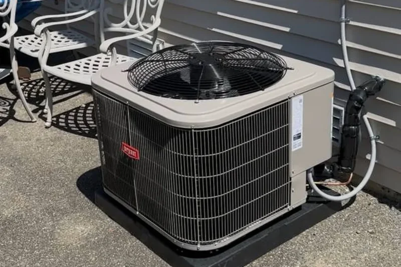 American Standard condenser installed beside a patio