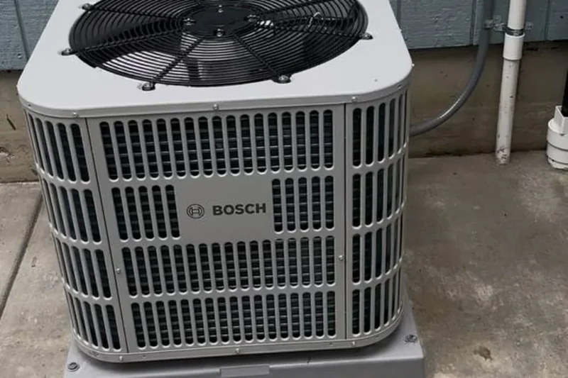 Bosch central air conditioner installed on a concrete pad