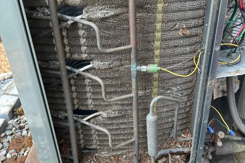 Open condenser coil and wiring during a repair