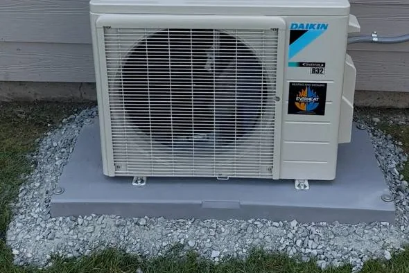 Daikin mini-split outdoor unit on a gravel bed
