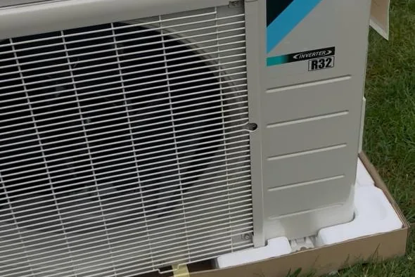 Daikin mini-split outdoor unit installed beside a lawn