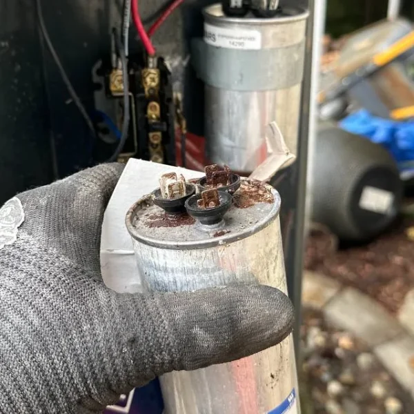 Failed run capacitor removed from an outdoor unit during a repair