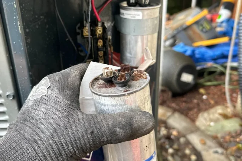Failed run capacitor removed from an outdoor unit during a repair
