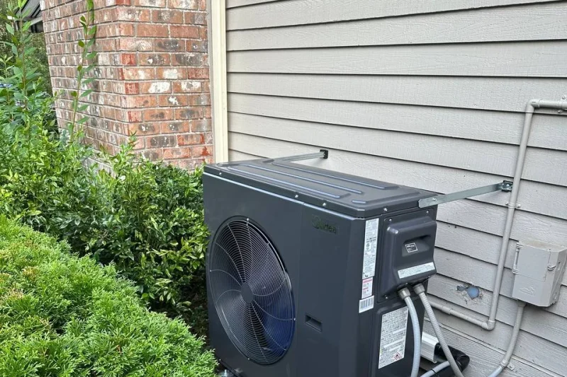 Heat pump outdoor unit installed beside a brick chimney