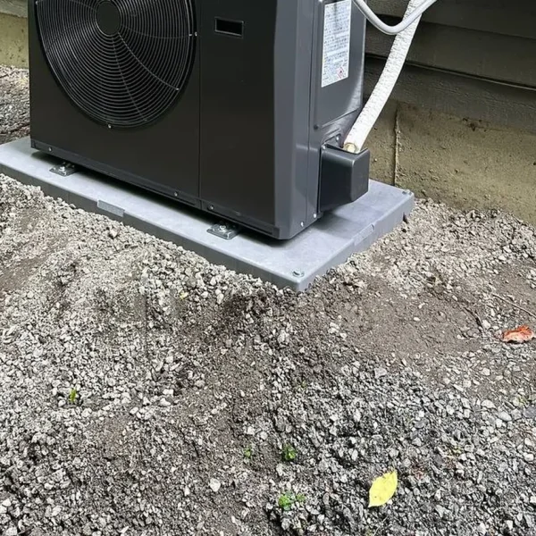 Midea heat pump outdoor unit installed on a composite pad
