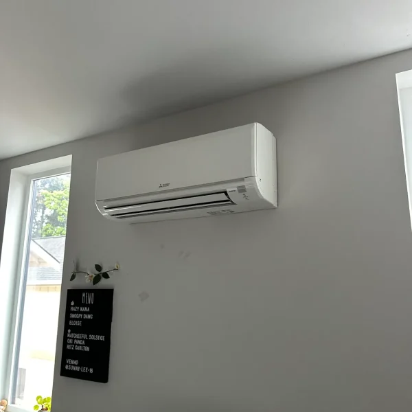 Mini-split indoor head mounted above a window