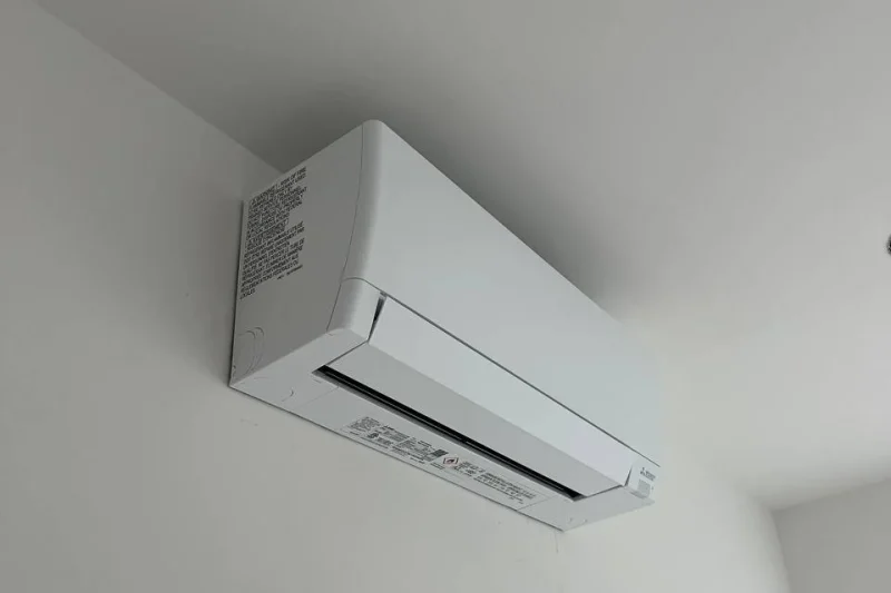 Ductless mini-split indoor head mounted in a room corner