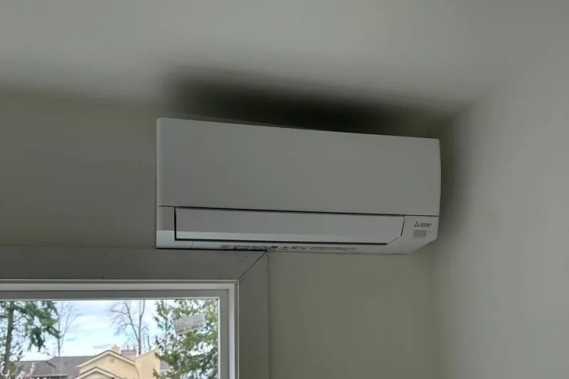 Ductless mini-split indoor head mounted over a window