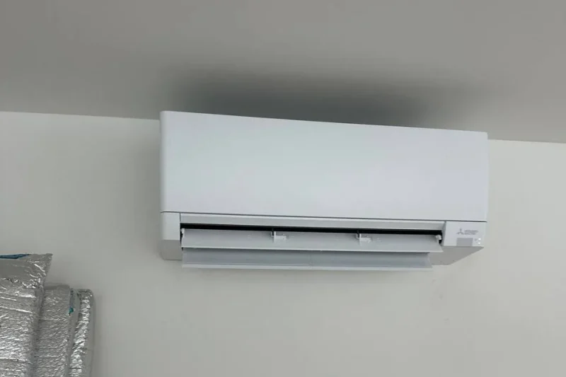 Ductless mini-split indoor head on a plain interior wall