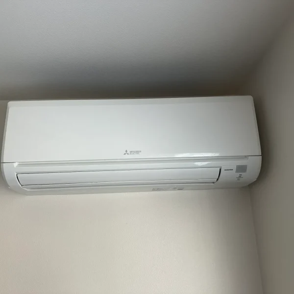 Mitsubishi mini-split indoor head on a plain interior wall