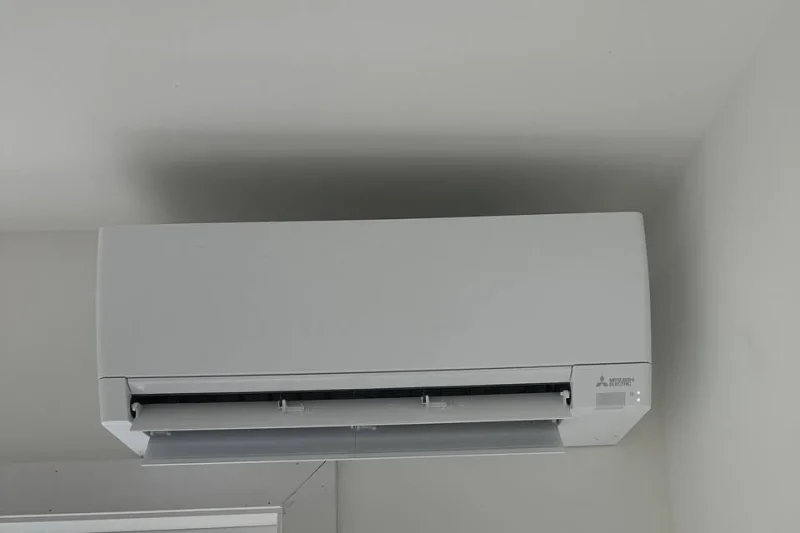Mitsubishi mini-split indoor head installed above a window