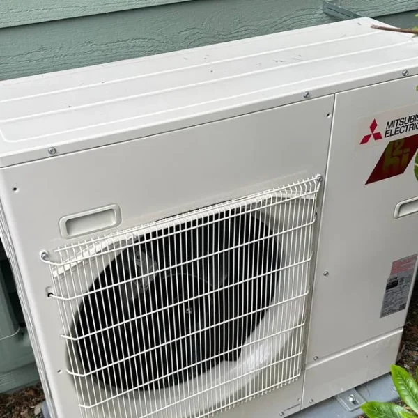 Mitsubishi outdoor unit installed Mitsubishi outdoor unit installed against sage siding