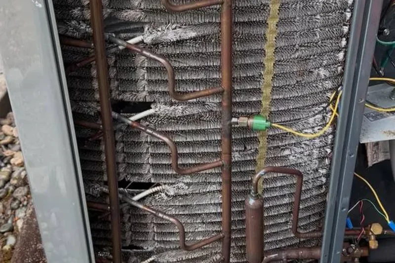 Open condenser coil during a service call on an outdoor unit