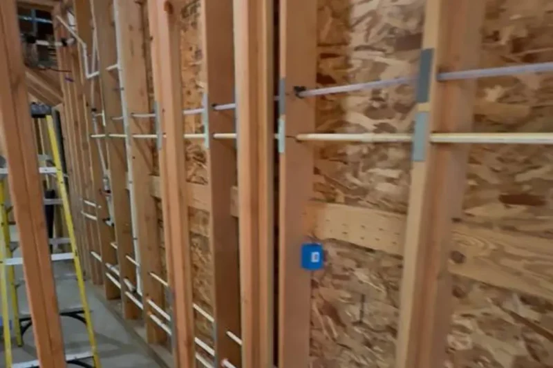 Refrigerant lines routed through framing during rough-in