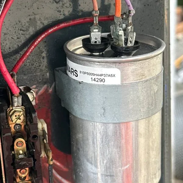 Run capacitor being replaced during a heating repair