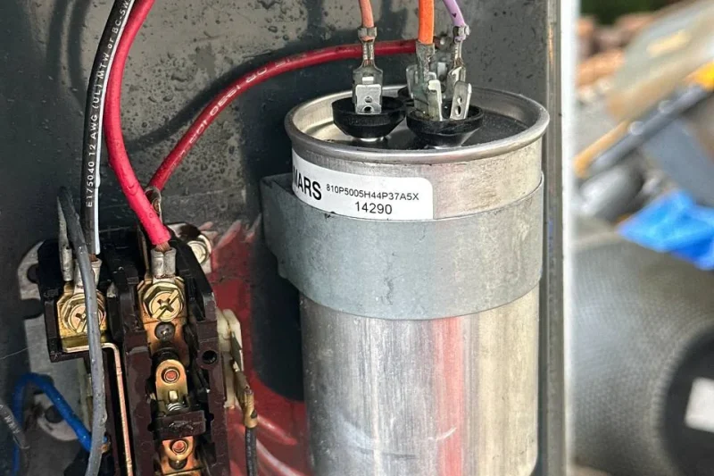 Run capacitor being replaced during a heating repair