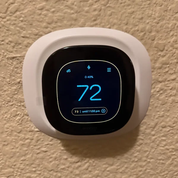 Smart thermostat on a wall set to 72 degrees