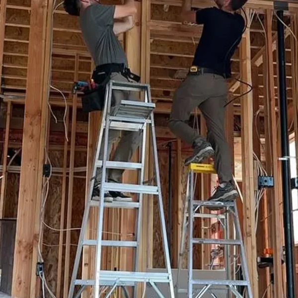 EverHeat technicians installing ductwork in a new build