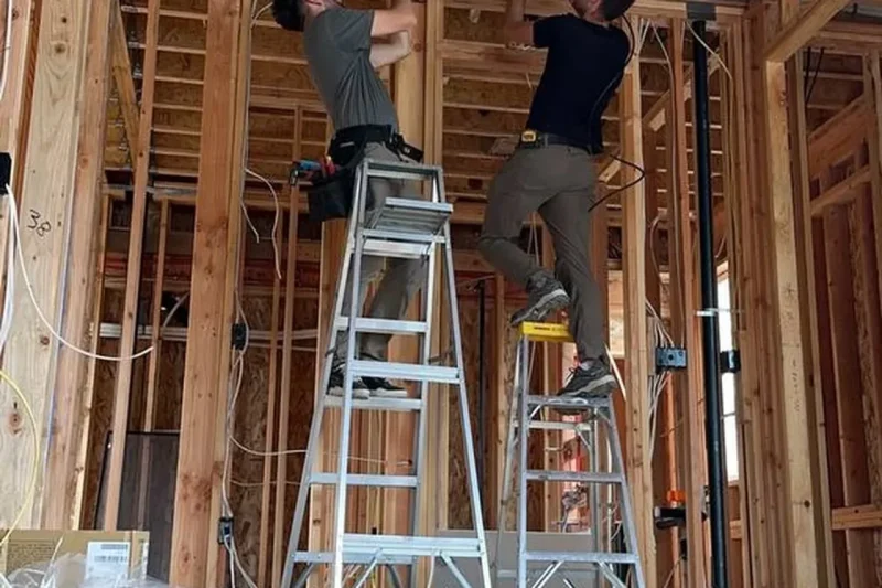 EverHeat technicians installing ductwork in a new build